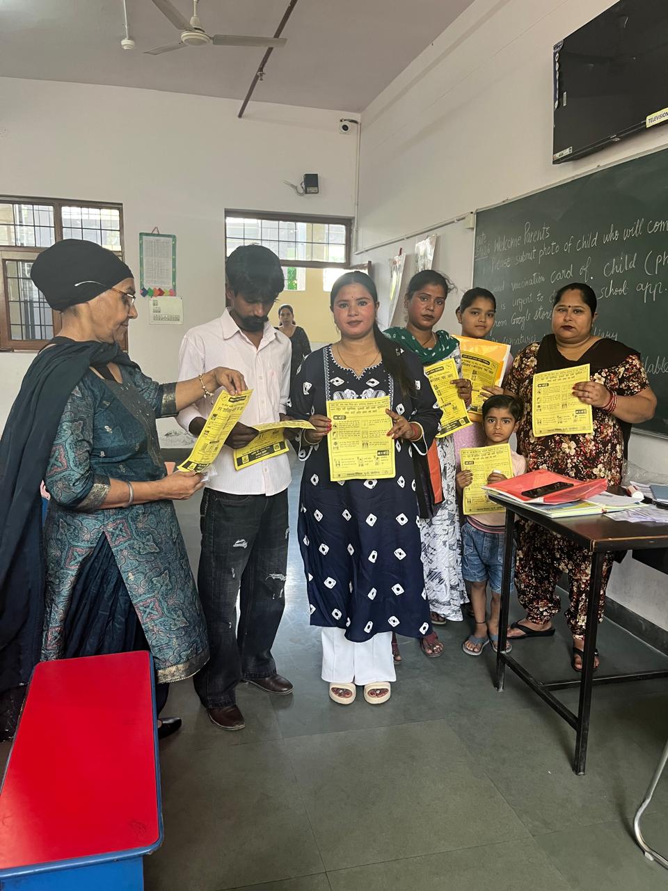Parents holding up yellow health flyers